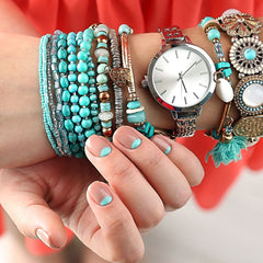 Handmade bracelets and accessories adorning a woman's wrist, showcasing vibrant craftsmanship and stylish jewellery trends